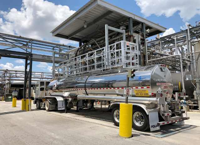 Fuel tanker loading refined petroleum products at distribution point